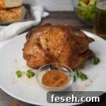 Whole chicken with seasonings on platter