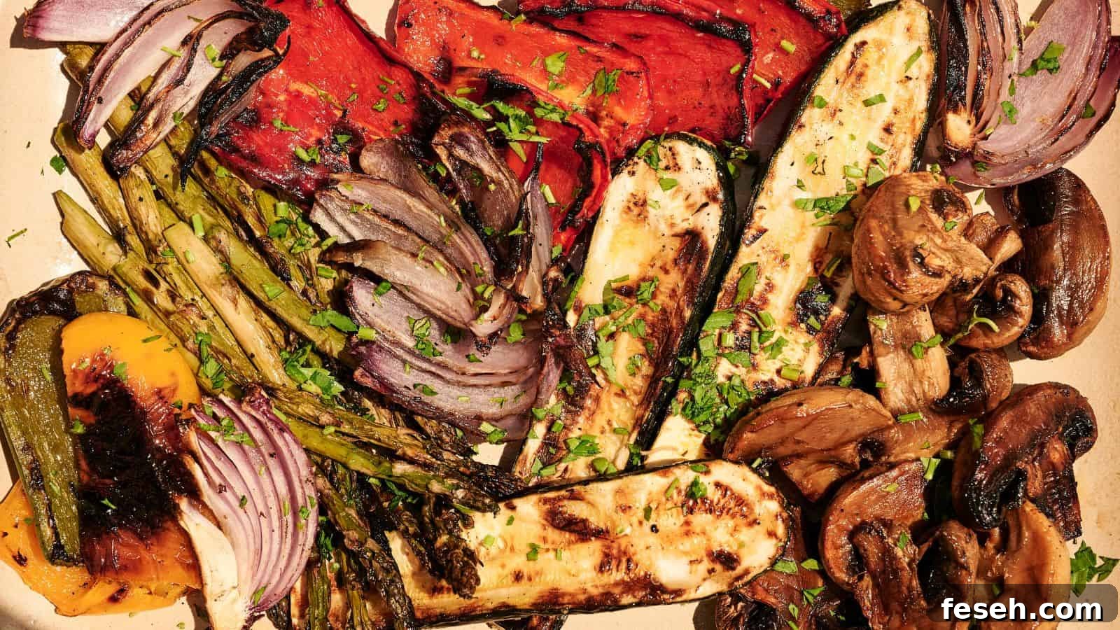 A platter of grilled vegetables including zucchini, mushrooms, asparagus, bell peppers, and red onions, garnished with chopped herbs.