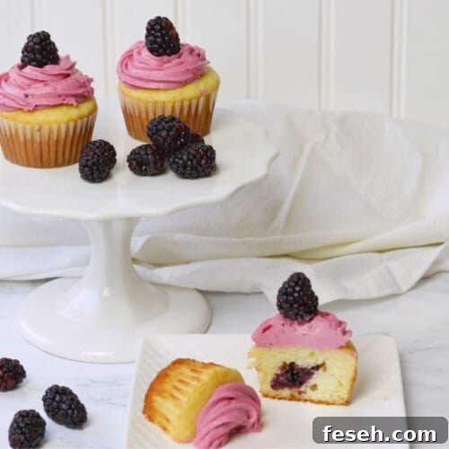 berry cupcakes on white cake platter