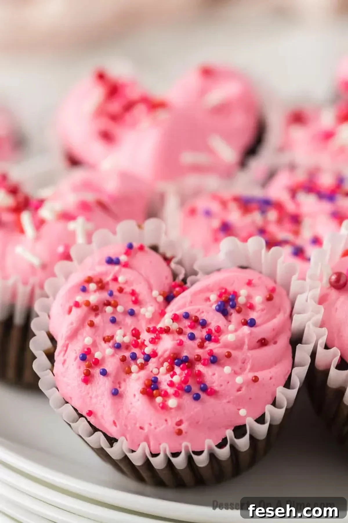 Heart cupcakes decorated with icing and sprinkles.