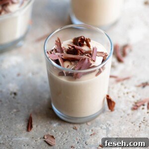 A close up of coffee ricotta cream (ricotta al caffe) in a small glass.