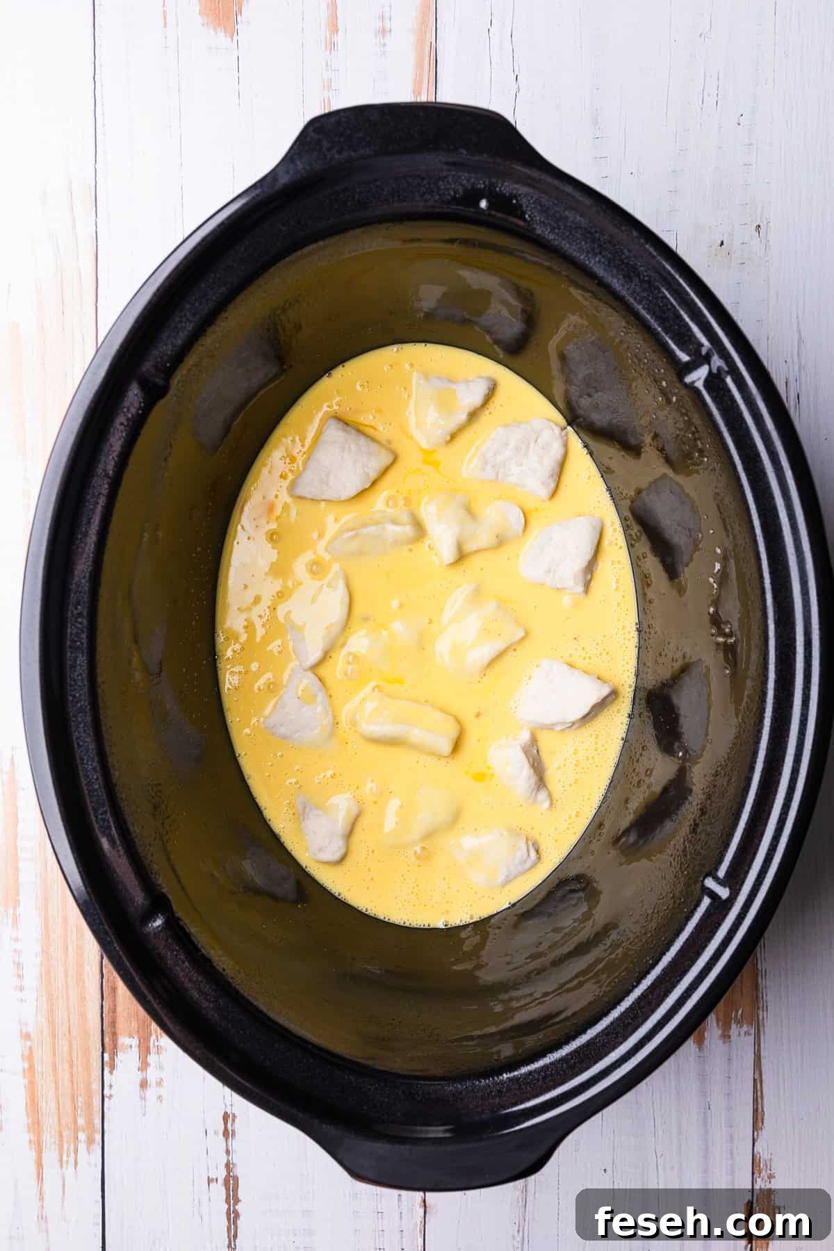 The beaten eggs added to the crockpot.