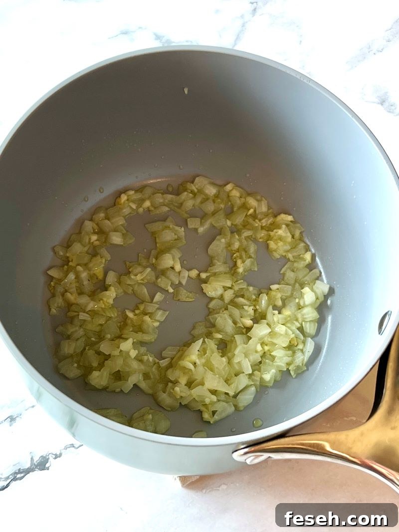 Sautéed onions and garlic in a saucepan.