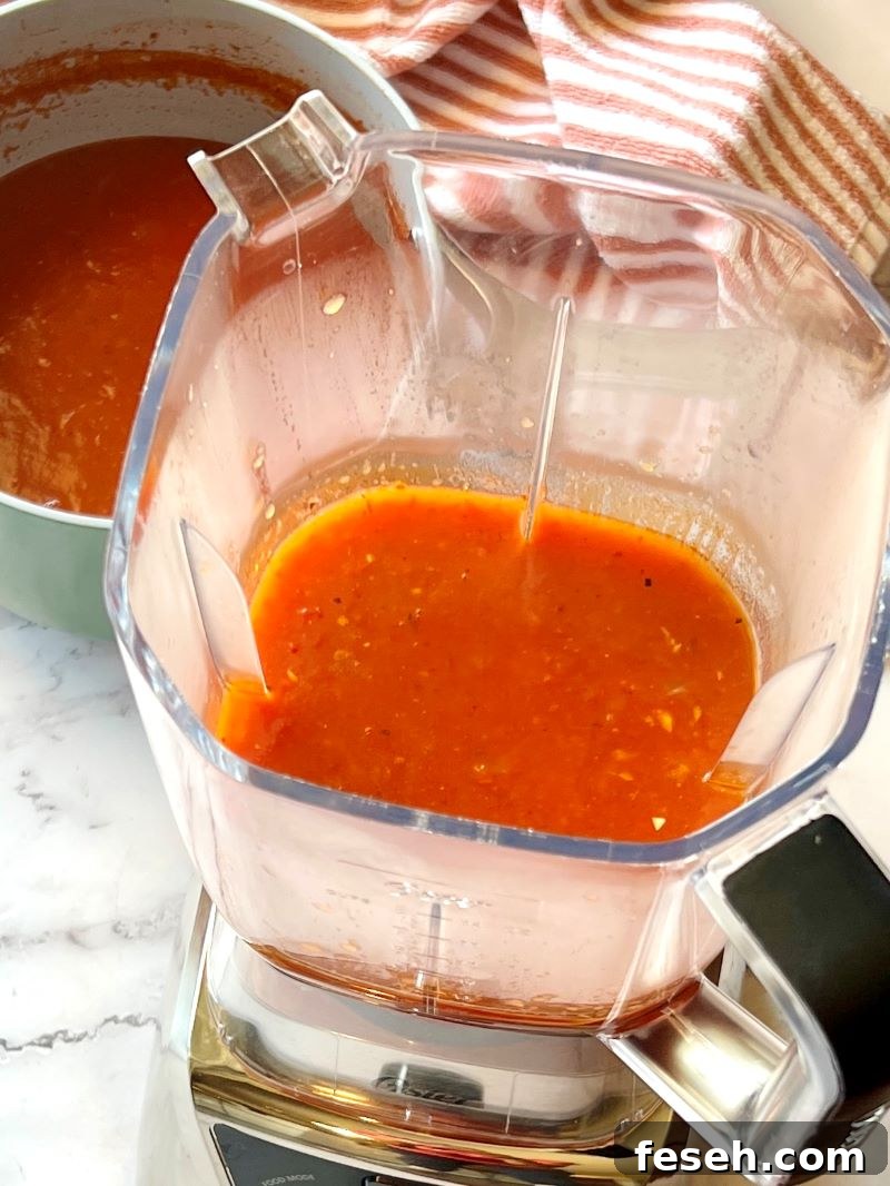 Half of the tomato soup blended in a blender.