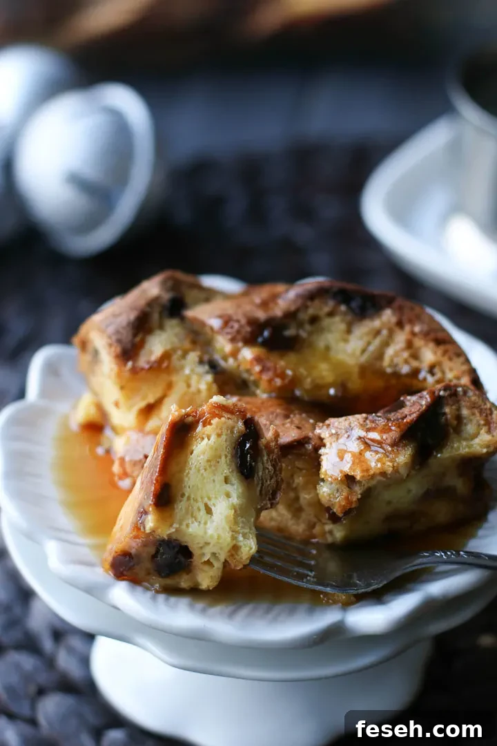 fork dipping panettone french toast into syrup