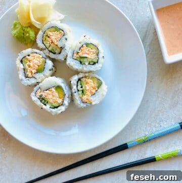 spicy crab roll on a plate with ginger and wasabi