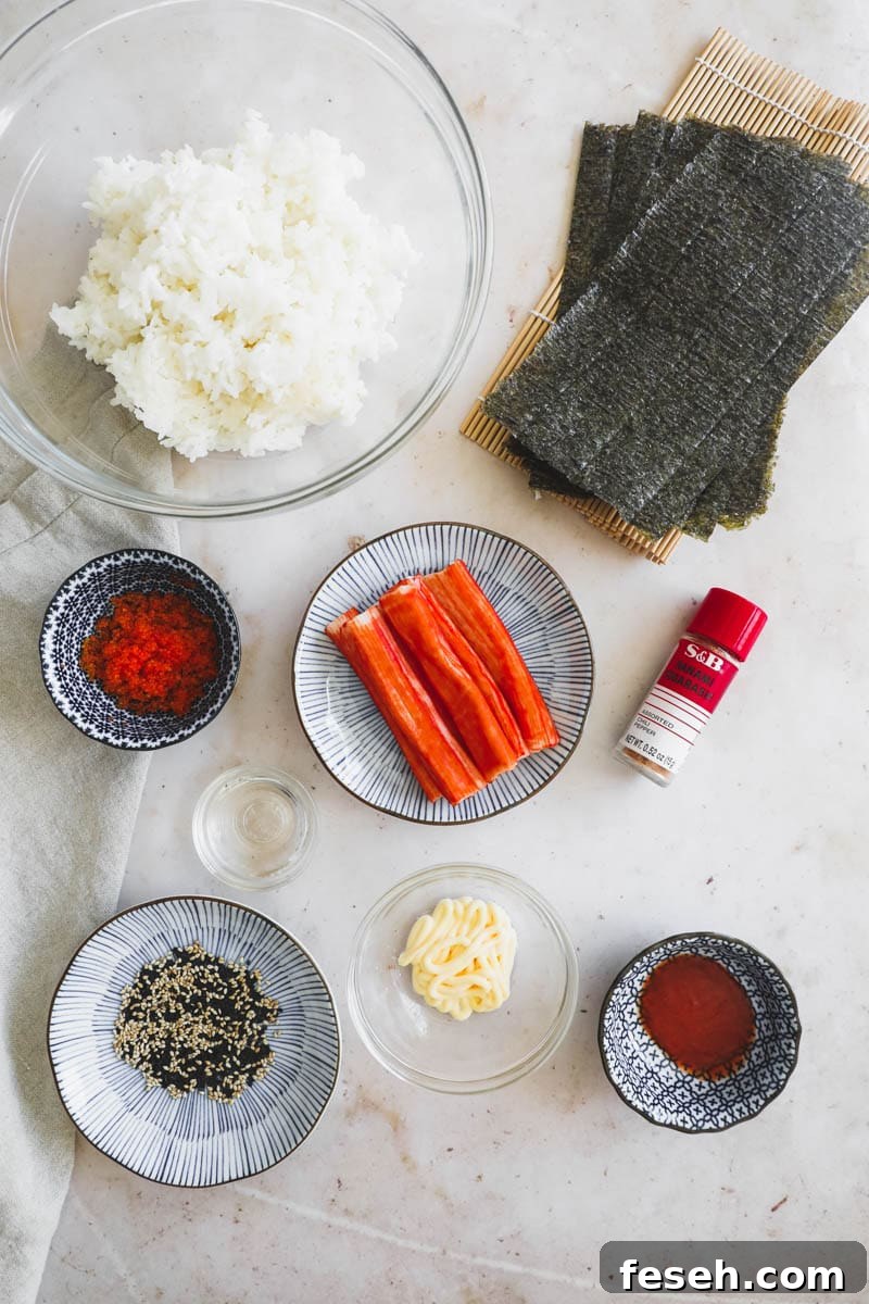 Ingredients separated in bowls and on plates to make spicy kani roll, including tobiko, sesame seeds, togarashi, sushi rice, nori, kewpie mayo, and imitation crab.
