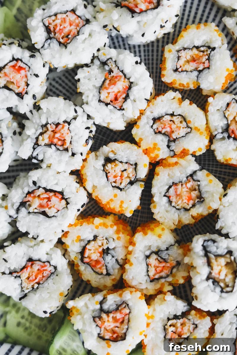 Closeup shot of spicy kani rolls with imitation crab, tobiko, rice, and sesame seeds.
