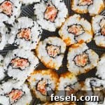 Closeup shot of spicy kani rolls with imitation crab, tobiko, rice, and sesame seeds.