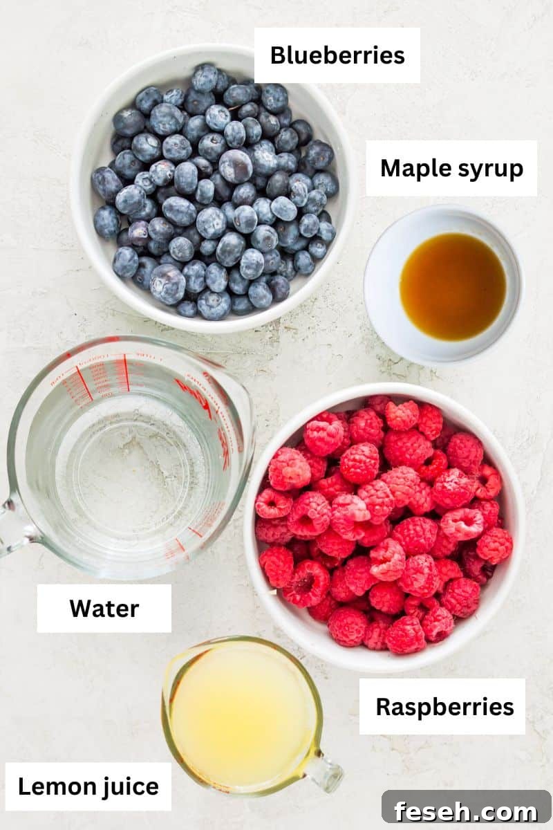 Bowls with different ingredients in the including blueberries, raspberries, water, lemon juice and maple syrup.