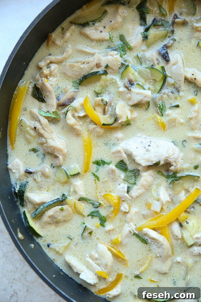 A large, deep skillet filled with Thai basil chicken.