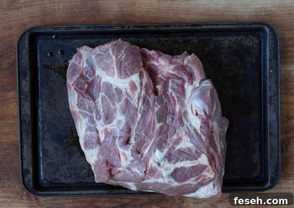Raw pork butt with marbling on a sheet