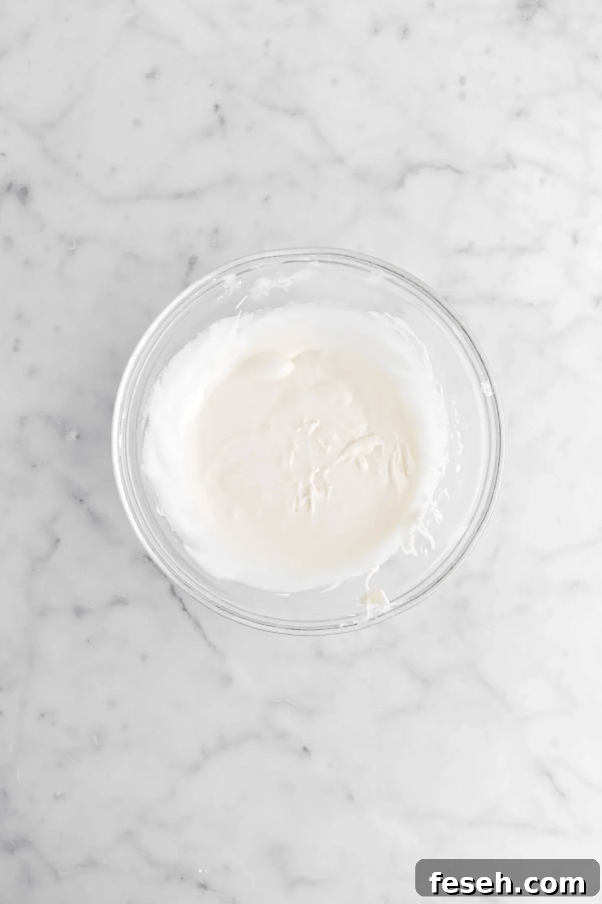 vanilla icing in glass bowl.