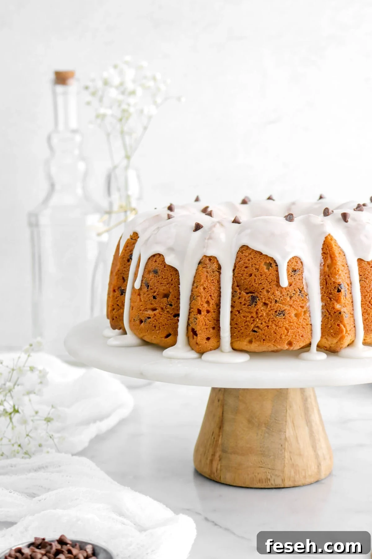 cropped close up of chocolate chip pound cake on cake stand.