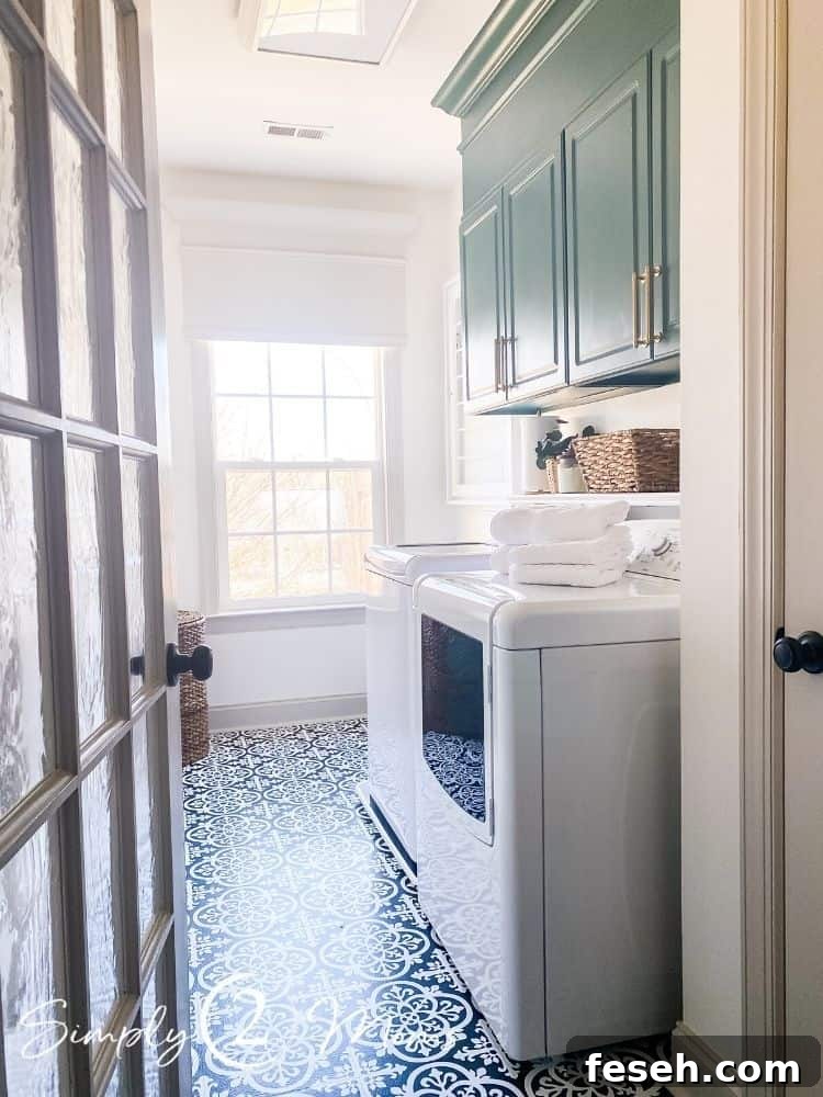 Farmhouse laundry room with painted cabinets and ceramic tile floors