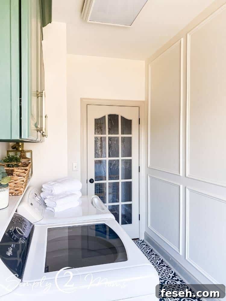 Laundry room with French doors and picture box moulding on the walls and painted green laminate cabinets
