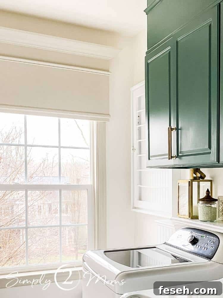Laundry room with French doors and picture box moulding on the walls and painted green laminate cabinets