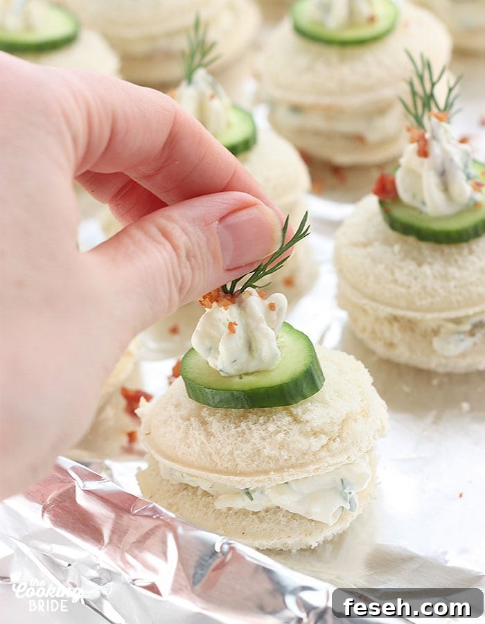 decorating each sandwich with a sprig of dill weed.