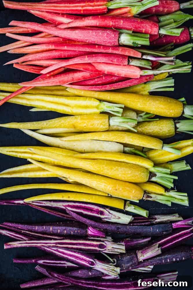 Rainbow carrots popped for roasting - Coral, Yellow and purple carrots, cut in half, up close and overhead shot.