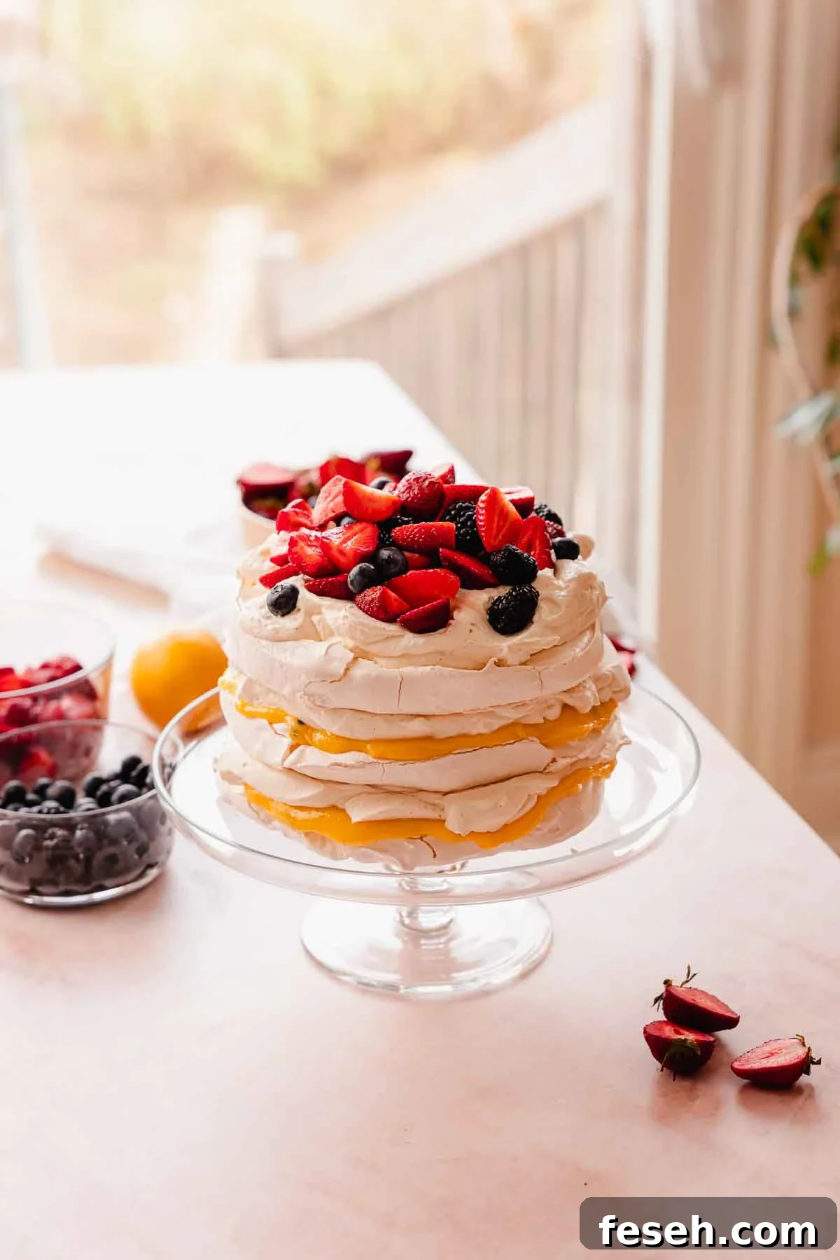 stacked pavlova cake with lemon passion fruit curd and berries