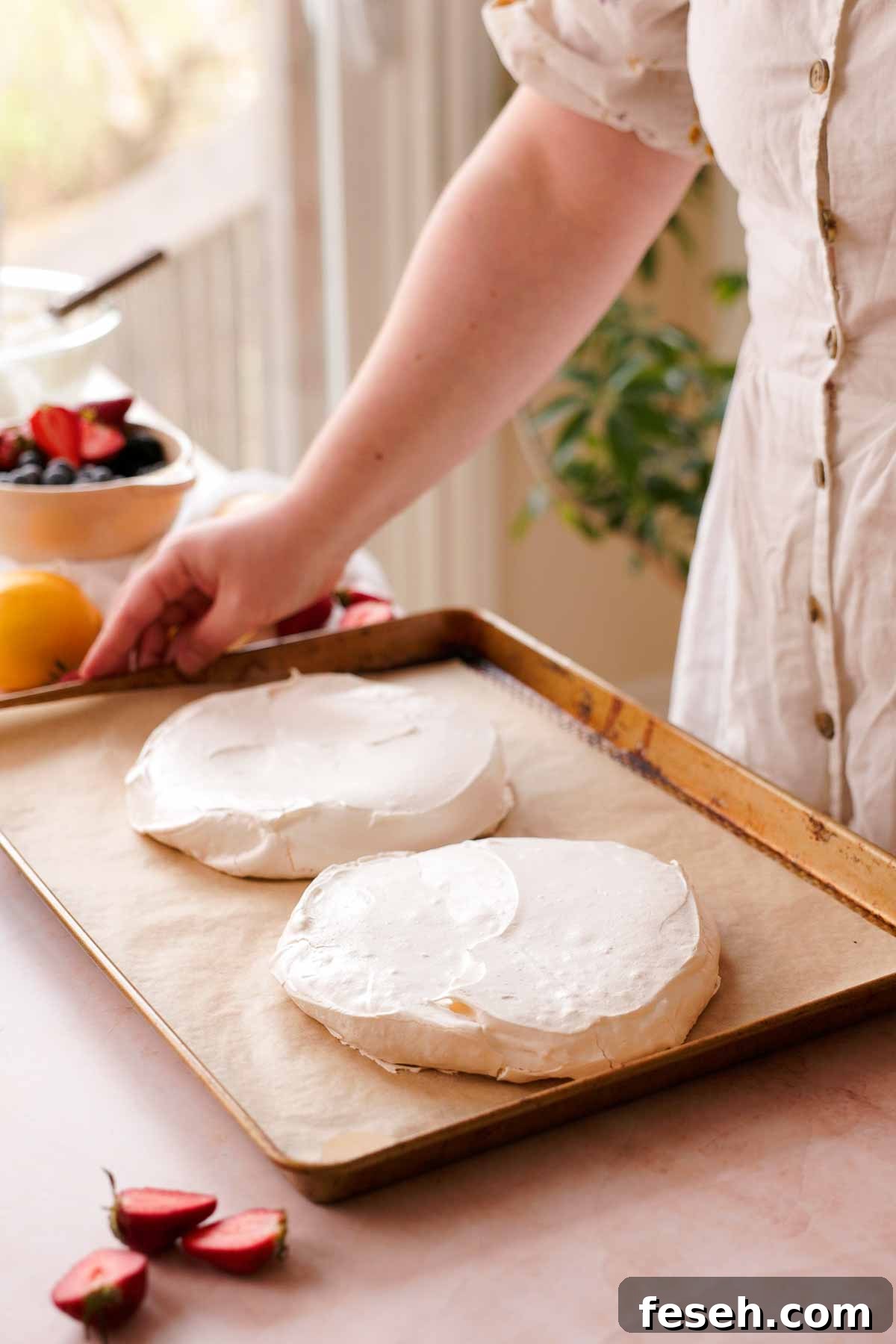 two baked pavlova layers on parchment paper