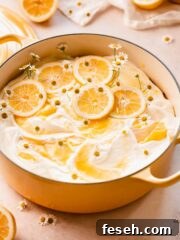 decorated lemon poke cake in a dutch oven