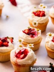 strawberry white chocolate cupcakes sitting on the table