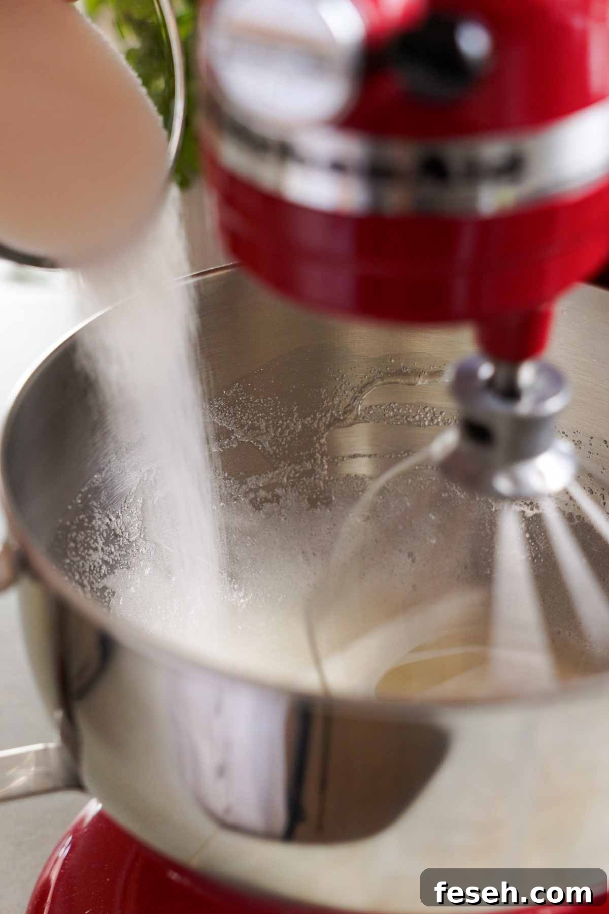 adding sugar gradually into egg whites in stand mixer