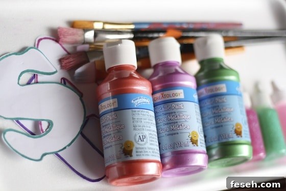 metallic paints, brushes, letters and glitter glue