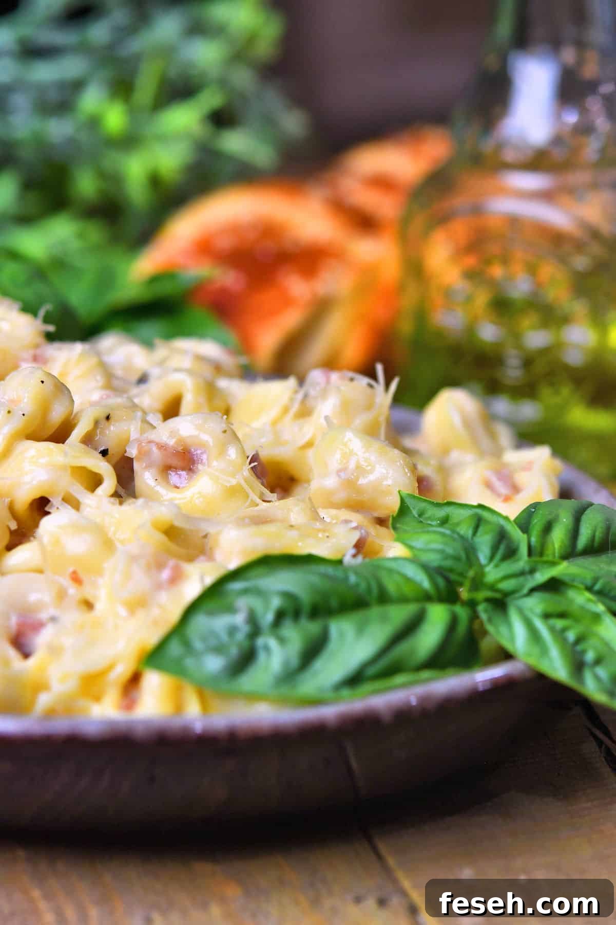 Tortellini Alla Panna on a plate on a table with oil and bread