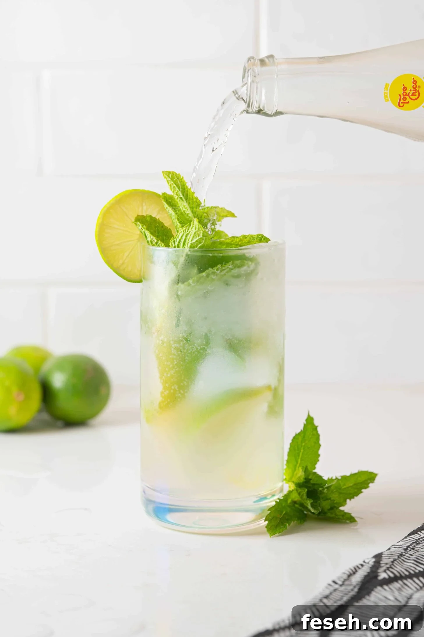 bubbly water pouring into a mojito