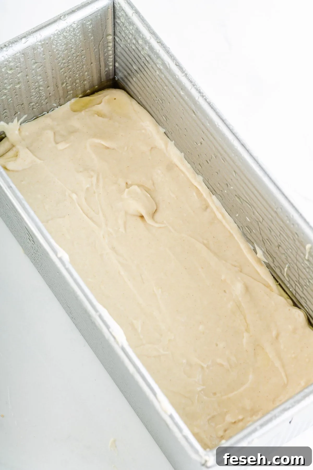 Gluten free bread dough in a bread pan.