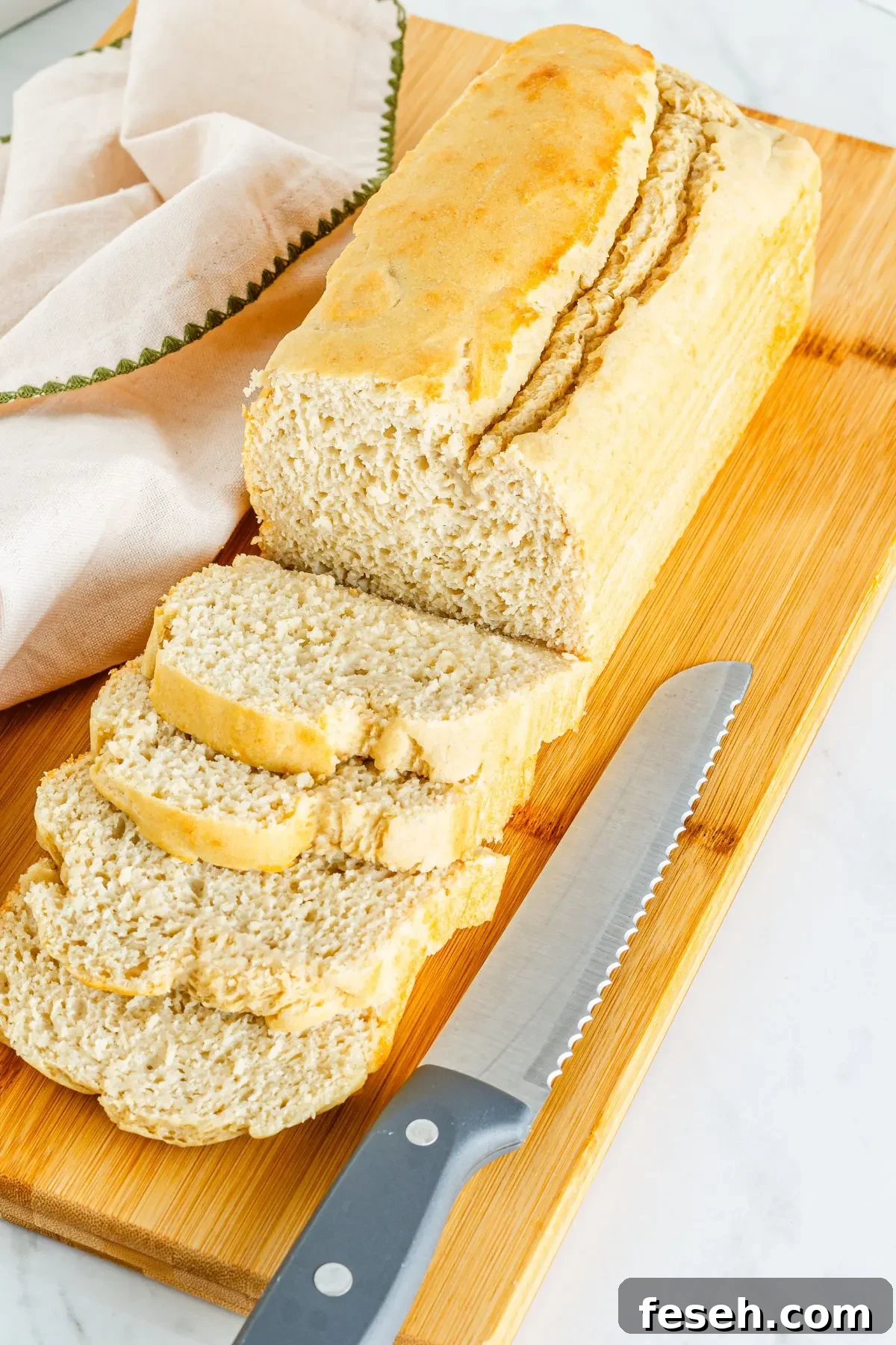 Sliced bread on a cutting board- gluten free bread. 