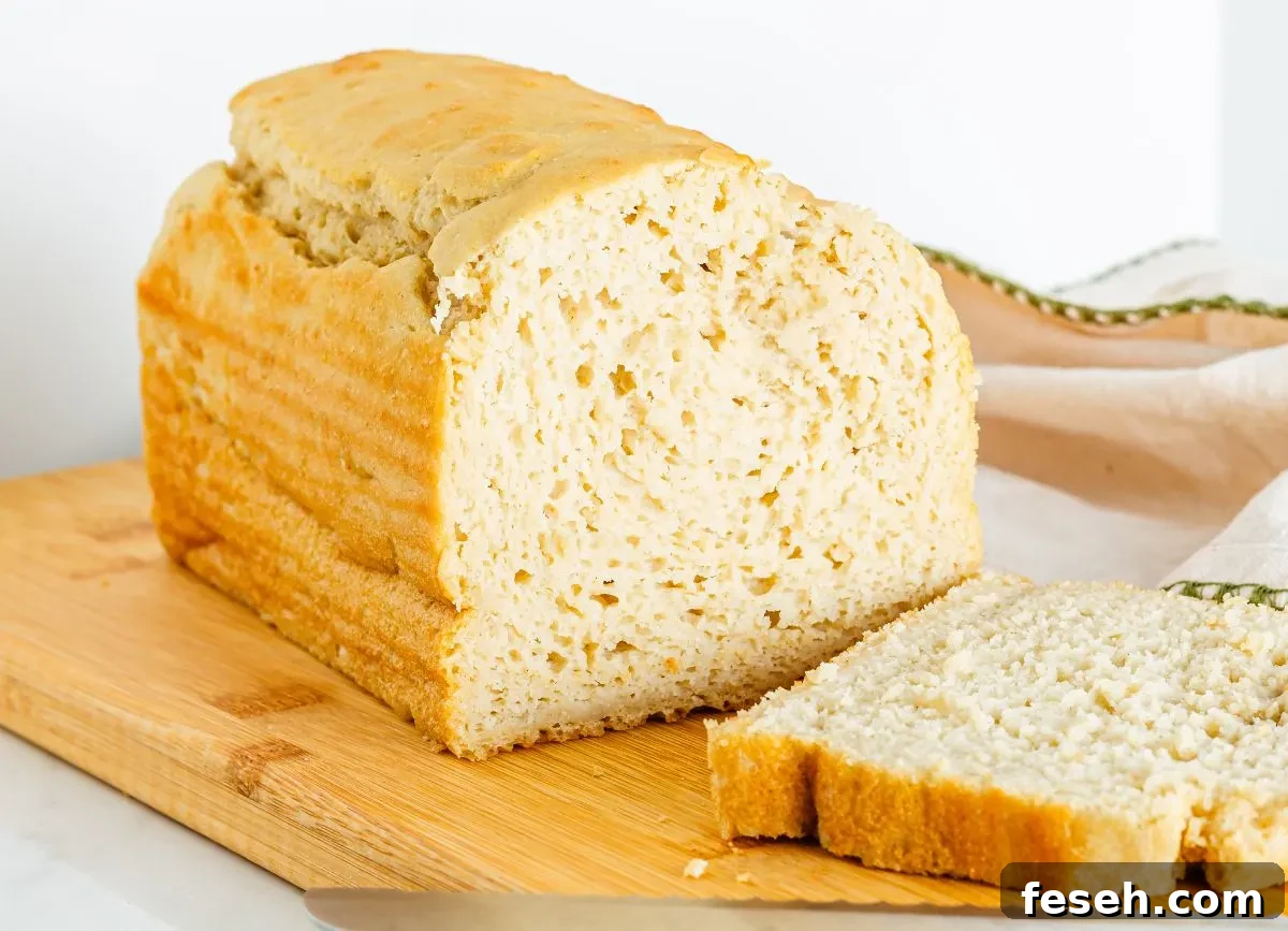 A loaf of gluten free dairy free bread with a slice next to it. 