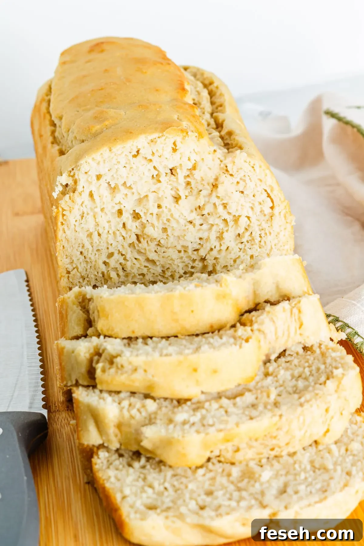 A loaf of gf bread being sliced. 