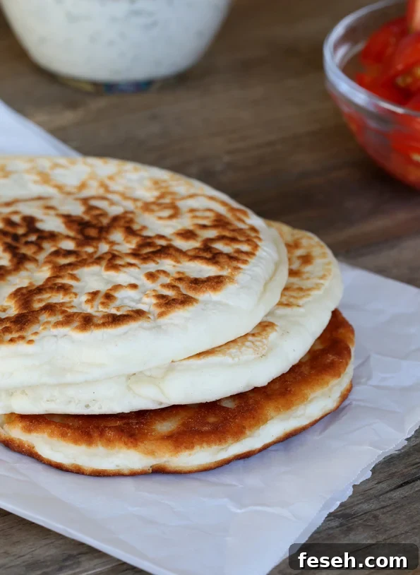 Stack of naan bread on white surface 