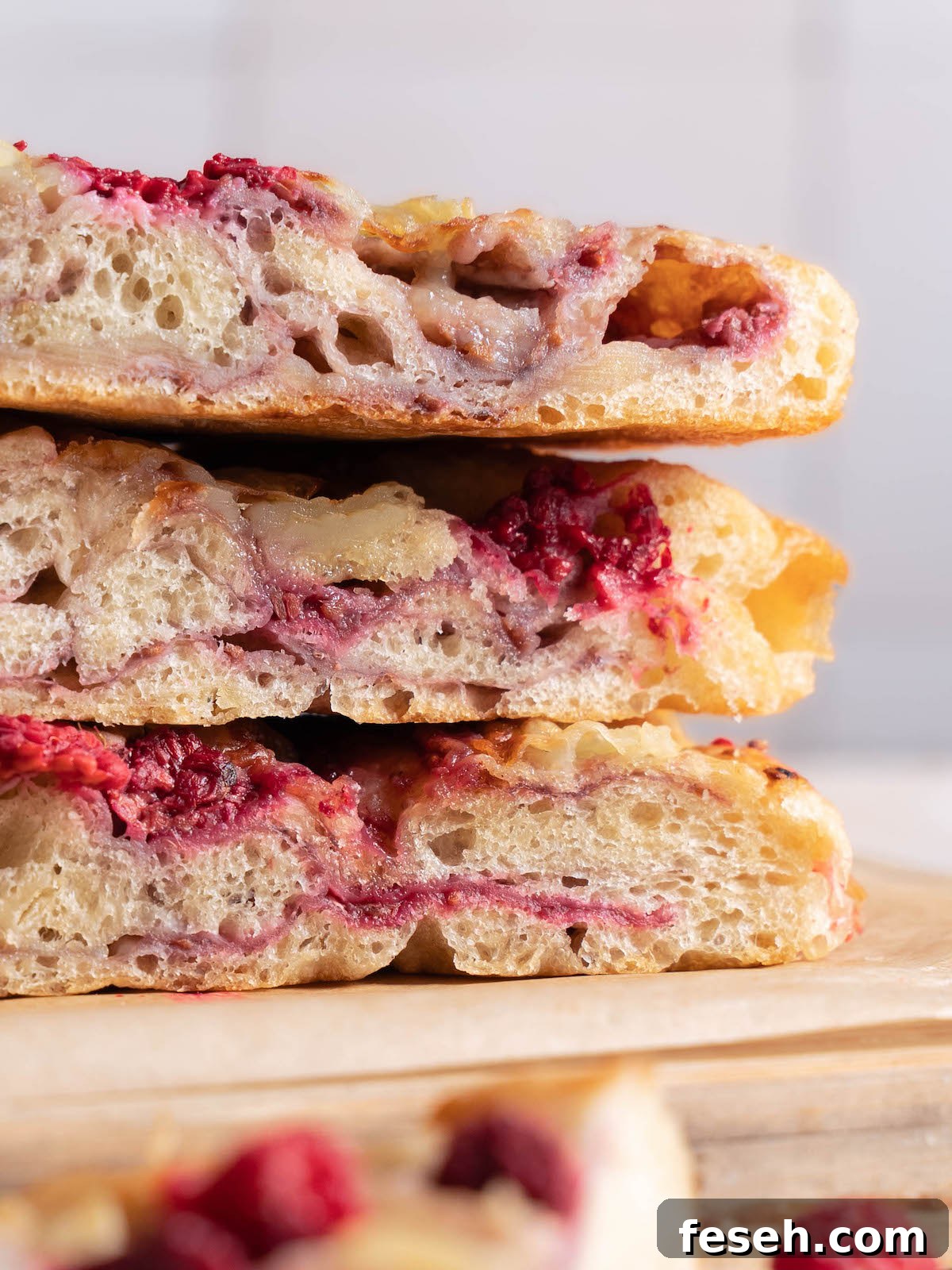 Up close view of bread to show layers of brie and raspberry jam
