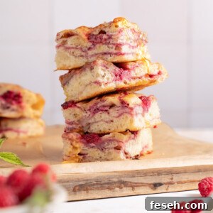Squares of raspberry brie focaccia bread stacked on top of each other
