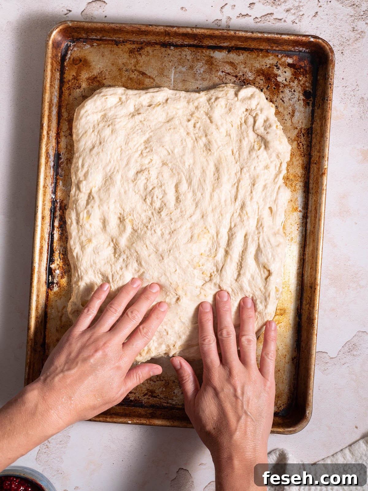 Stretching focaccia dough into a rectangle