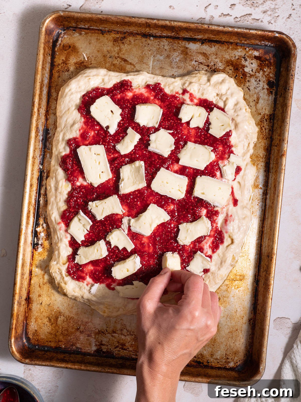 Adding brie to focaccia bread