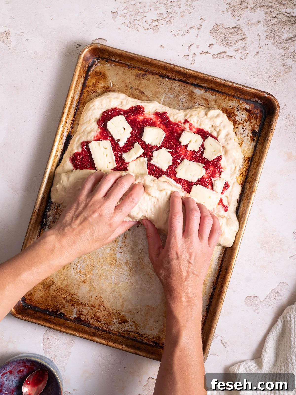 Rolling stuffed focaccia into a log