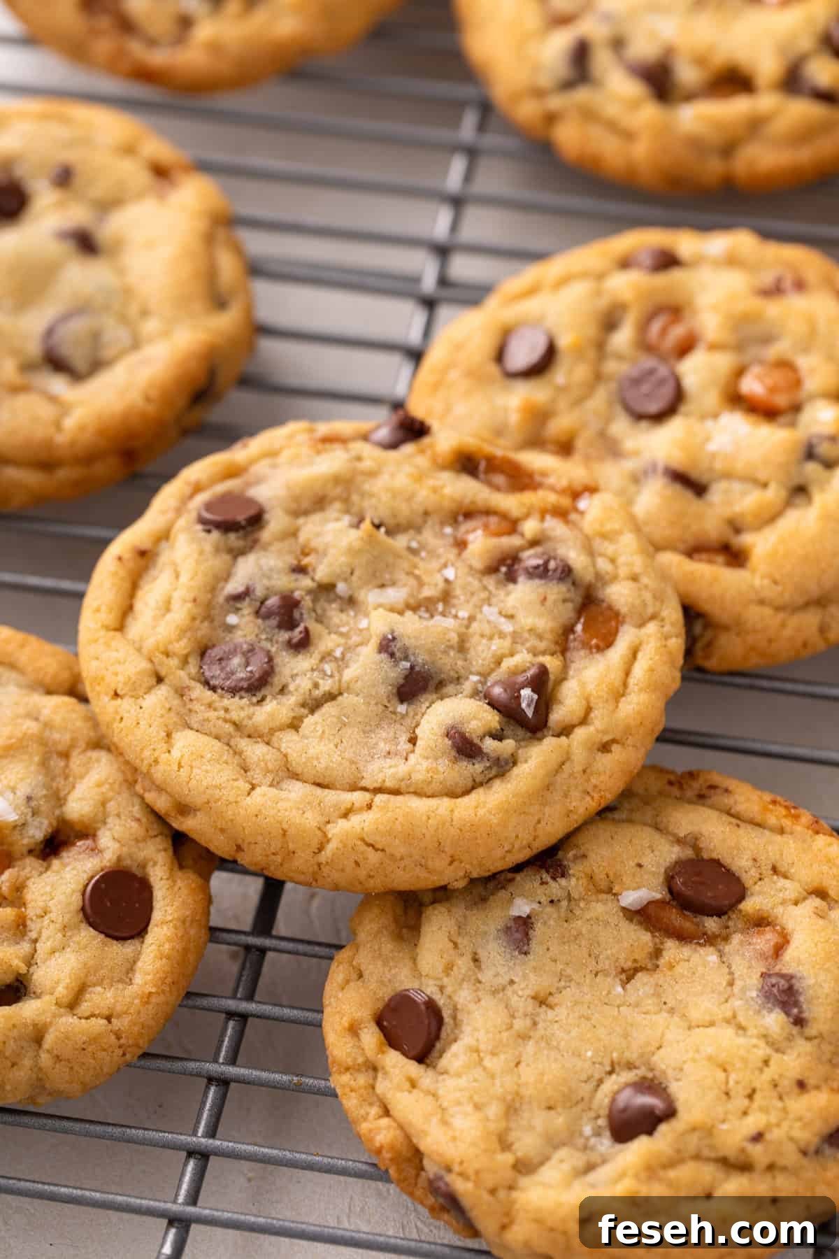 Close up of salted caramel chocolate chip cookies on a wire rack.