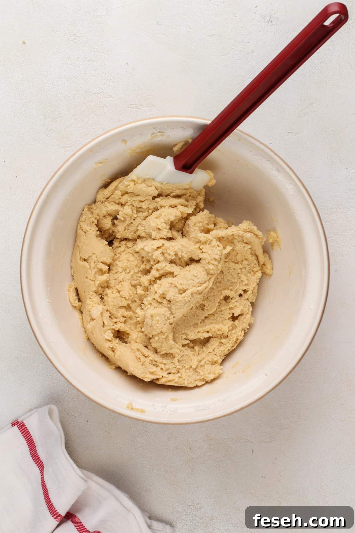 Dough base for salted caramel chocolate chip cookies in a mixing bowl.