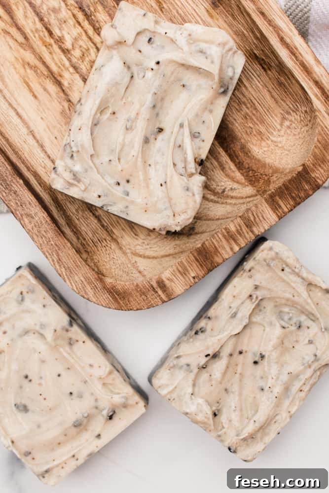 Homemade layered and textured coffee soap bars on a wooden curing rack.