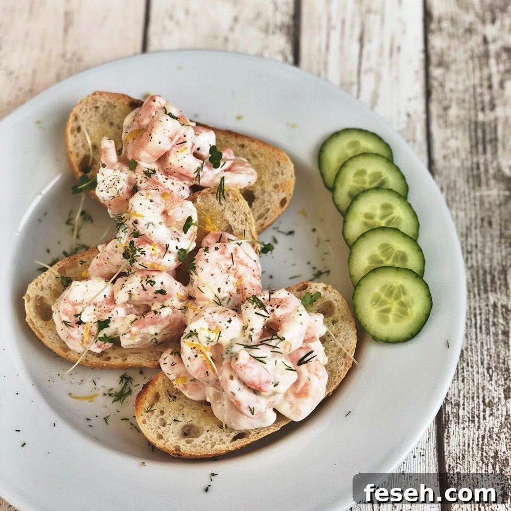 sourdough rye bread lightly toasted and topped with king prawns in a creamy dressing