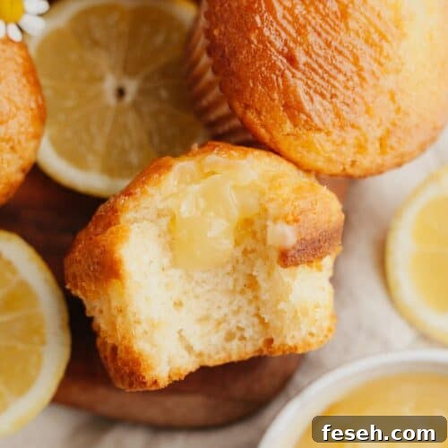 A close up of a lemon curd muffin with a bite taken out of it.