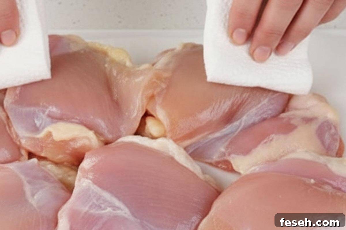 Patting the chicken dry