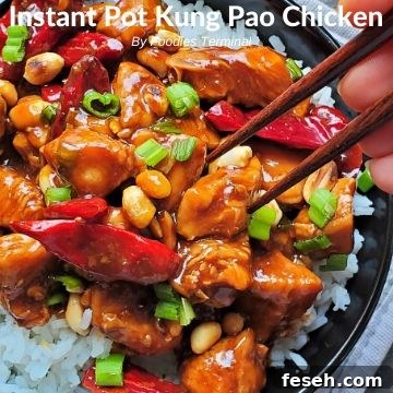 Kung Pao chicken on a bed of rive with chopsticks trying to lift a piece of chicken