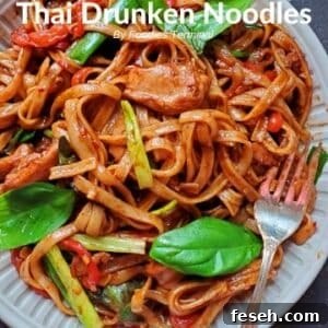 instant pot drunken noodles with basil in a beige plate