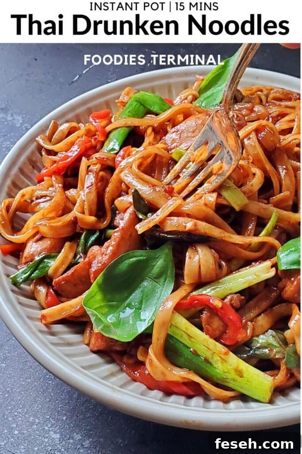 instant pot thai drunken noodles pad kee mao being lifted with a fork